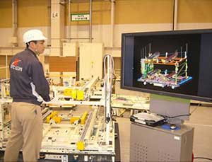 Workers do assembly using a 3D model as a guide