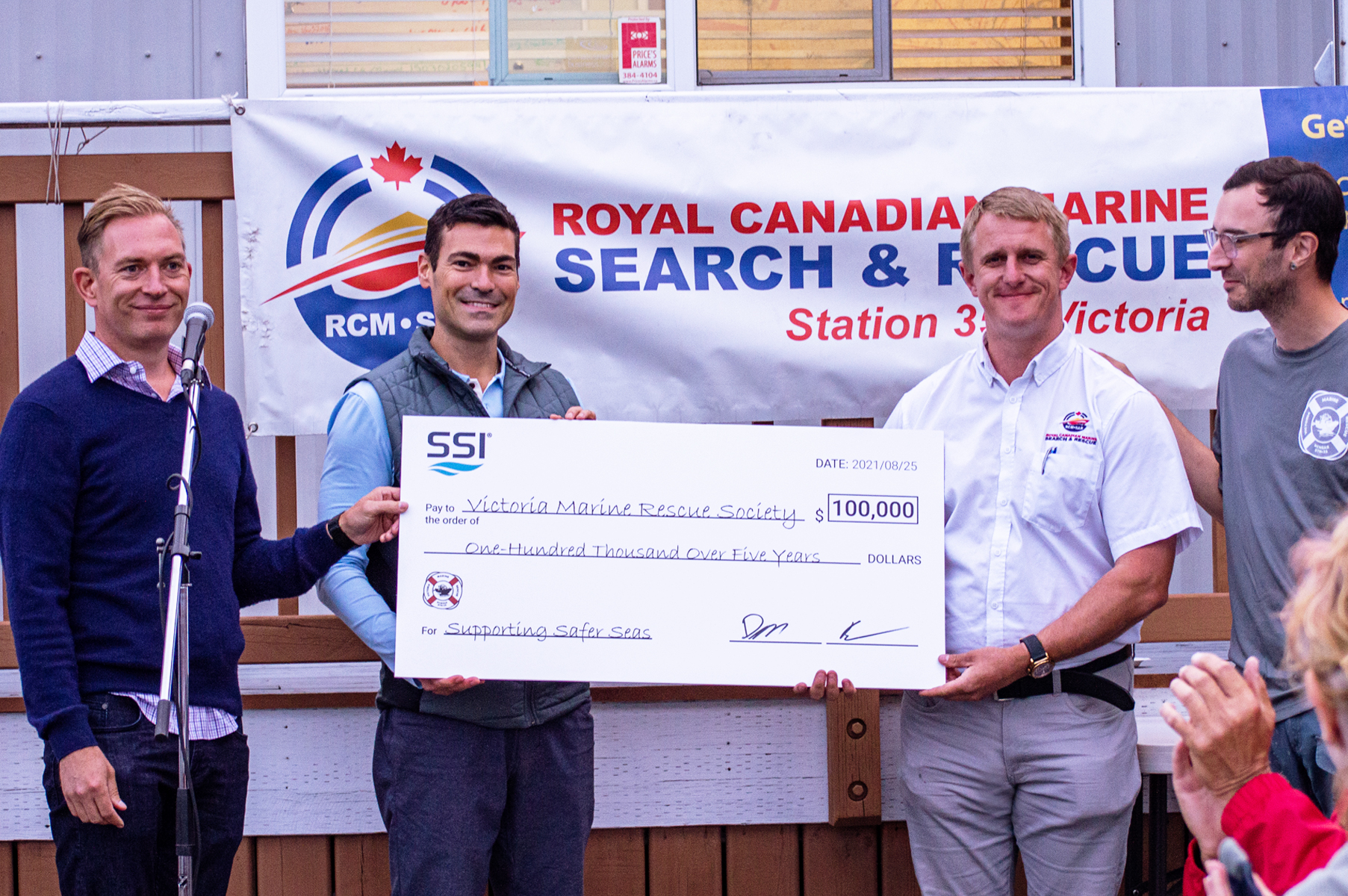 SSI co-CEOs hand big check  for 100,000 to VMRS and RCMSAR Station 35 lead